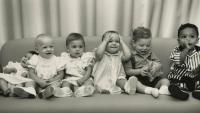 babies sit on a couch
